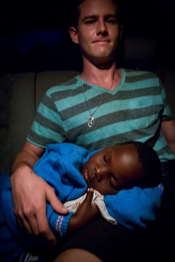 Child sleeping on adult's lap
