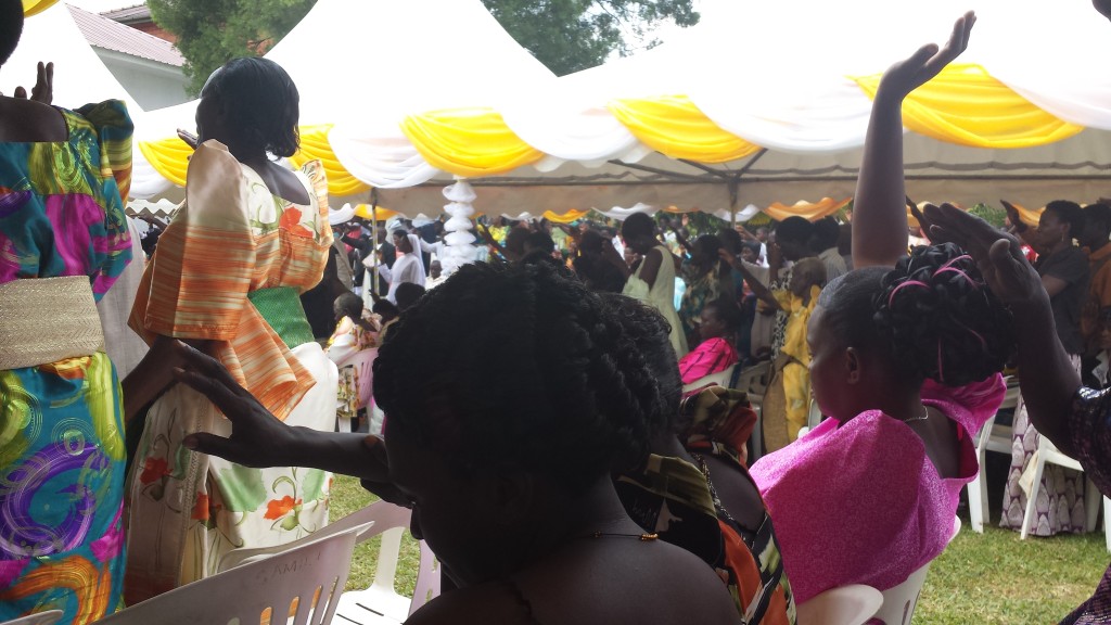 Christians in Nkokonjeru raising their hands in prayer, celebrating Sr. Lucia's special day