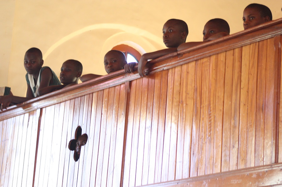 Children from St. Alphonsus Demonstration School, one of CARITAS For Children's partner schools, flow up to the balcony