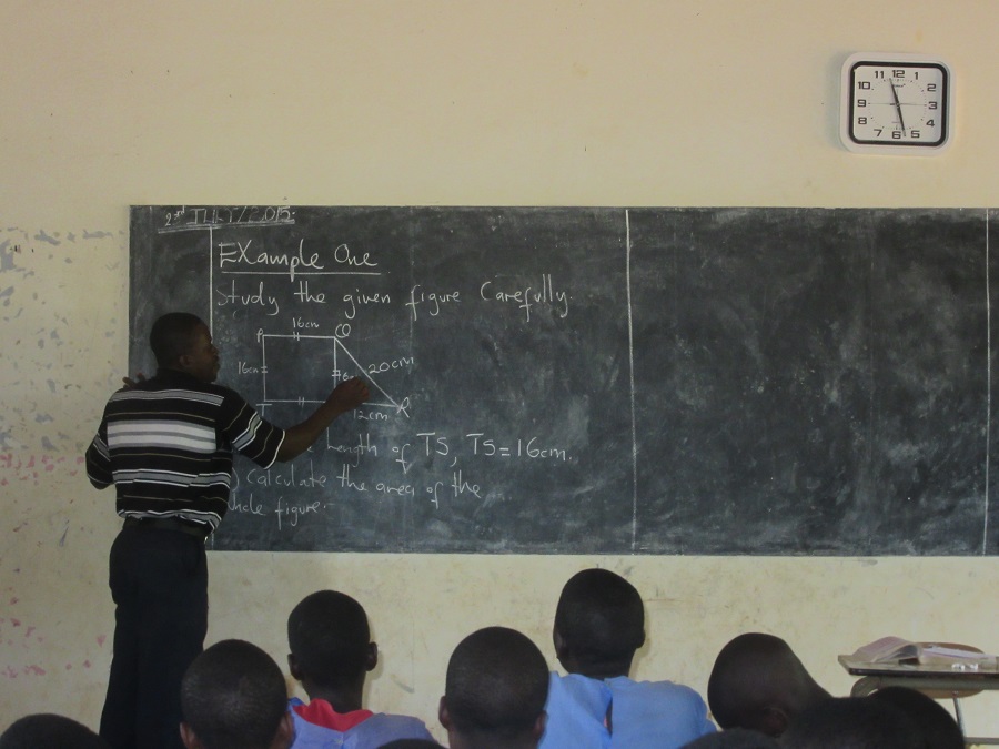 During his vacations from the seminary –classes begin again in September – Frank has been volunteering at local schools and and helping out around the CARITAS office. Twice a week, Frank teaches mathematics to the P7 class at St. Paul's Secondary School School in Nkokonjeru. He has also been teaching a combination of mathematics, English, and religious education classes at St. Henry and at St. Claire. To get to St. Henry's, which is past Kisoga (i.e. halfway to Mukono), Frank drives a bodaboda. Above, Frank explains a problem about calculating the areas of a polygon. 